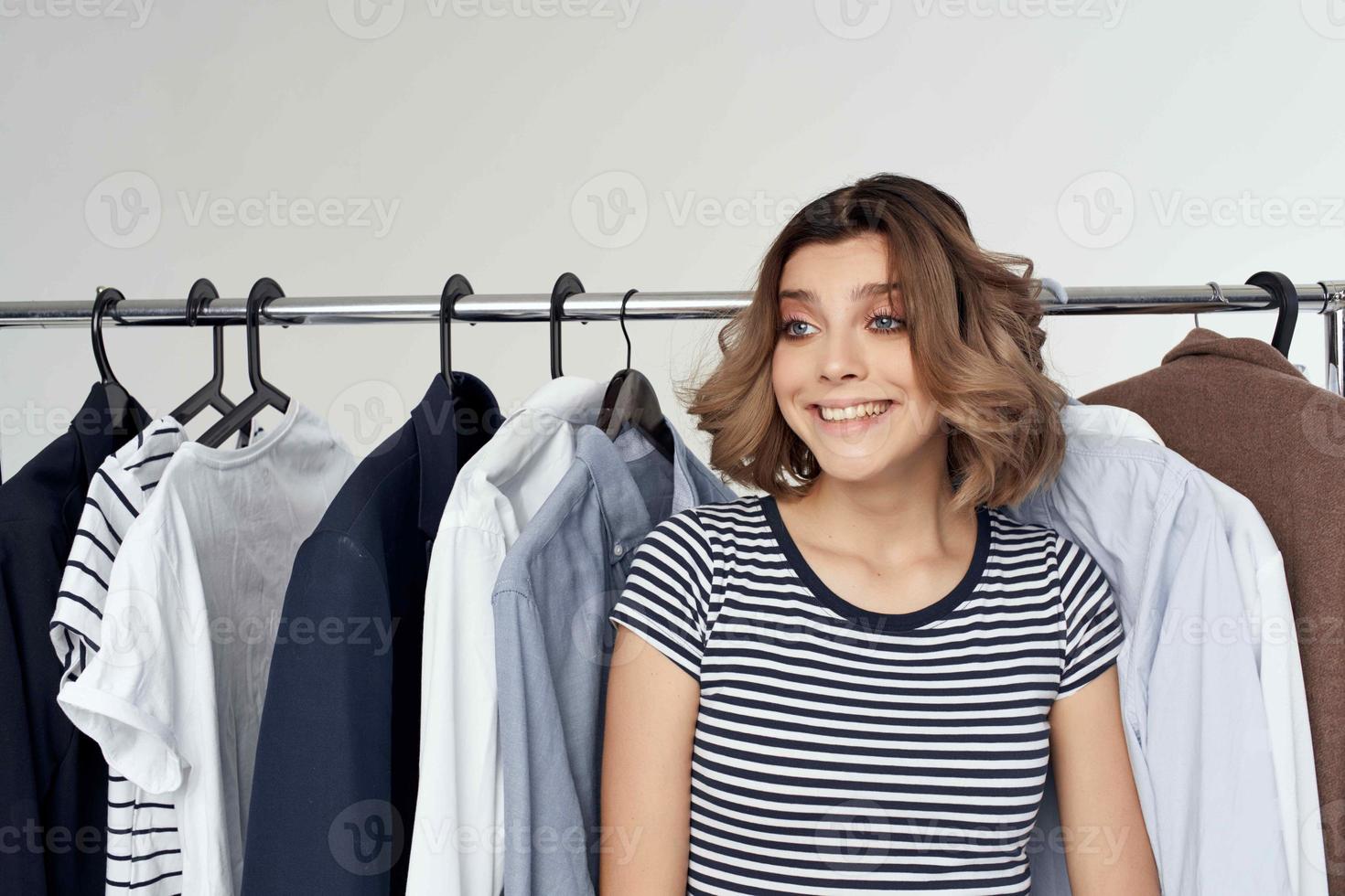 beautiful woman next to clothes fashion fun isolated background photo