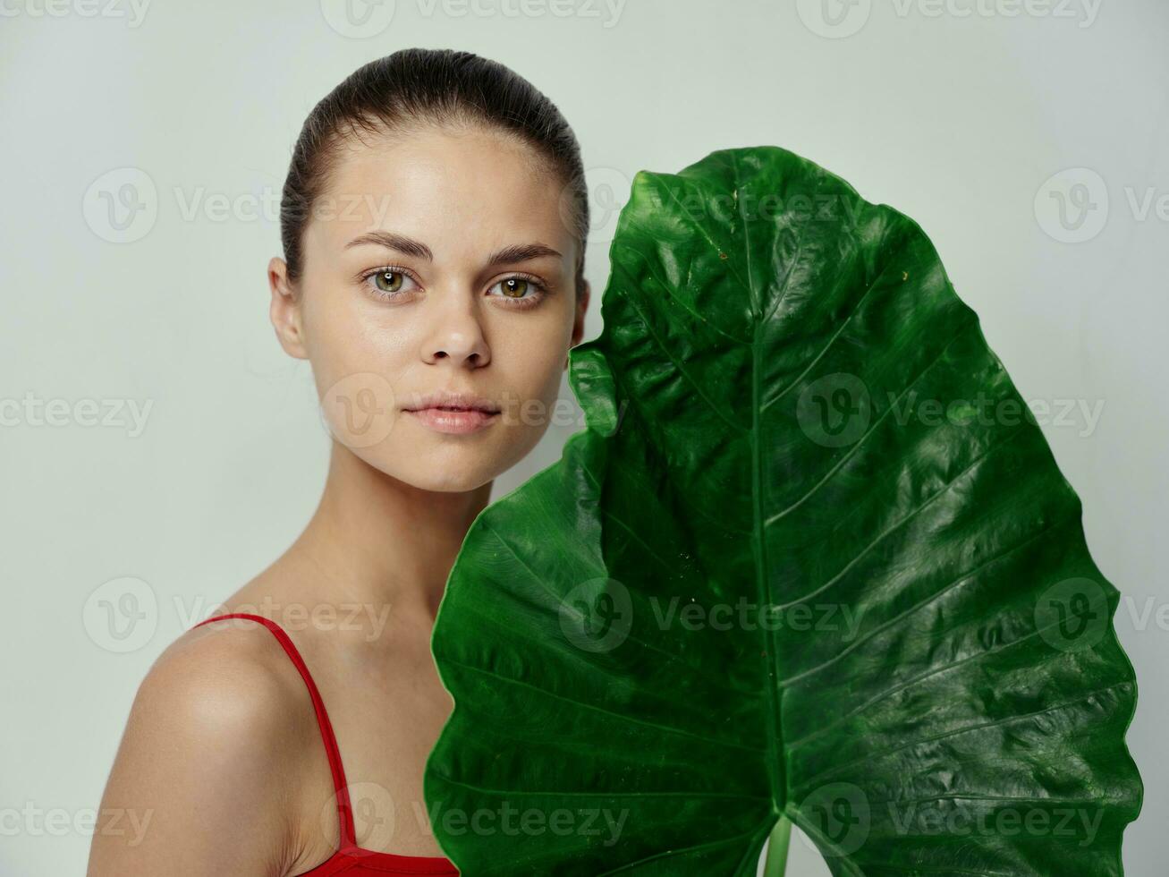 clean skin cosmetology young woman with green palm leaf photo