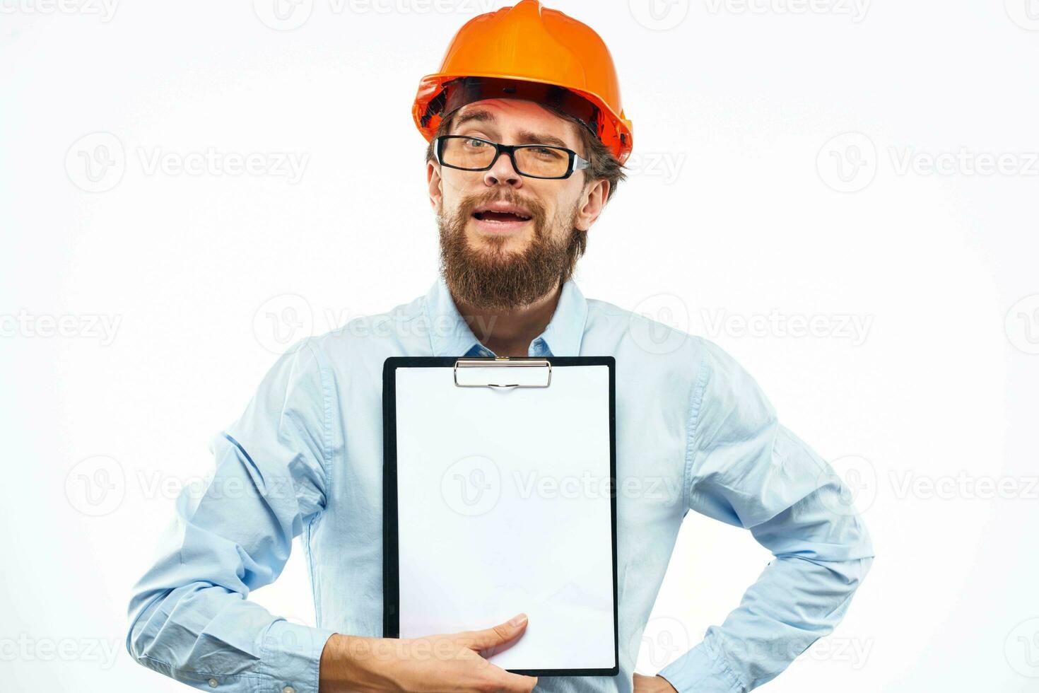 A man in an orange hard hat with documents Industrial activity work photo