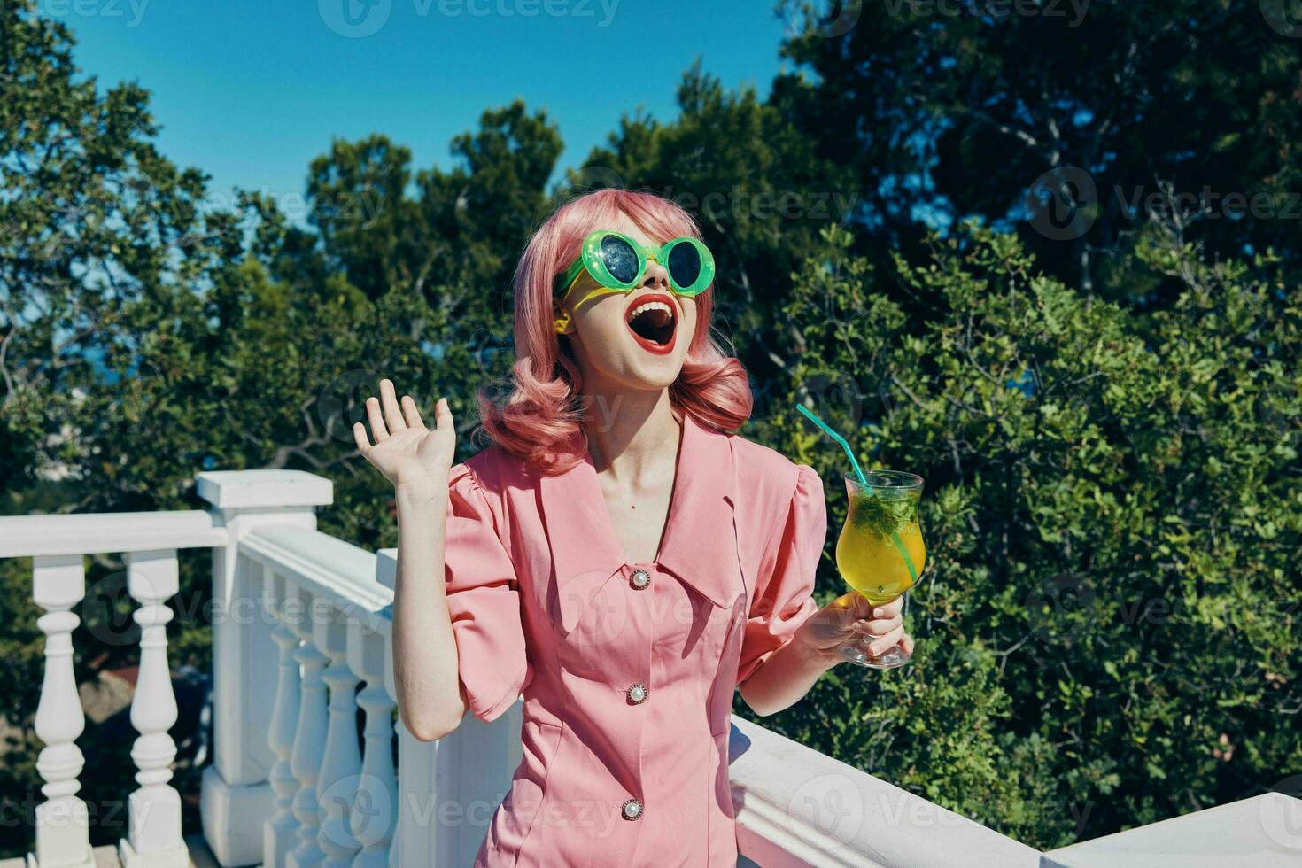 portrait of beautiful woman in green sunglasses with cocktail in summer outdoors unaltered photo