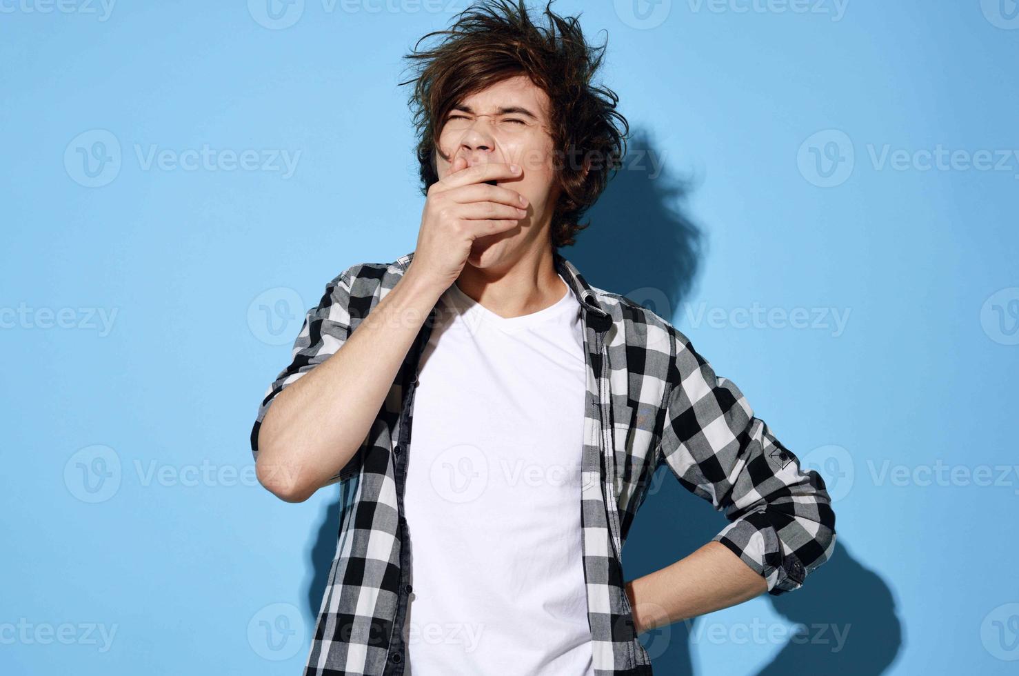 Cheerful guy in plaid shirt tousled hair fashion modern style photo