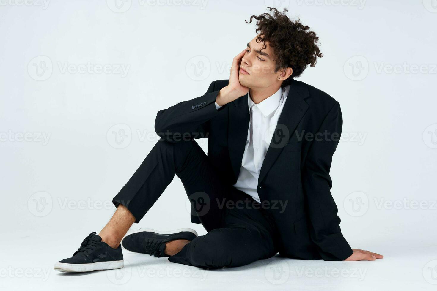 guy in black jacket sitting on the floor fashion elegant style photo