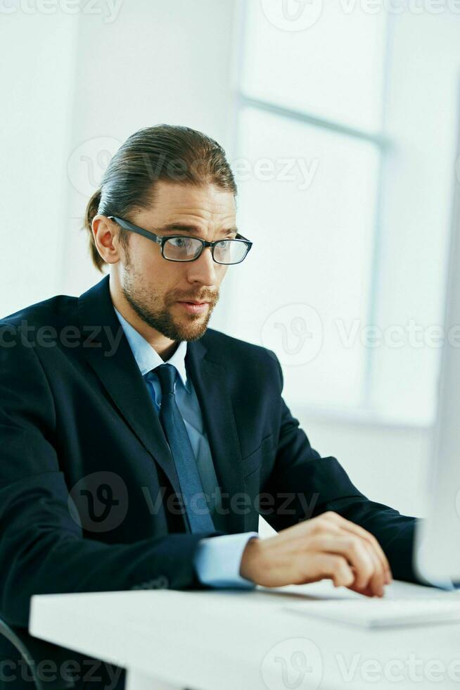 business man at his desk office typing on keyboard photo