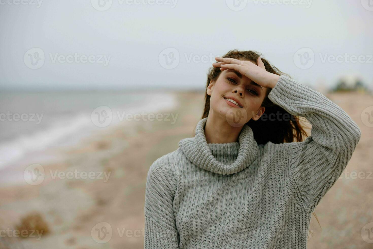 cheerful woman with long hair on the beach nature landscape walk Happy female relaxing photo