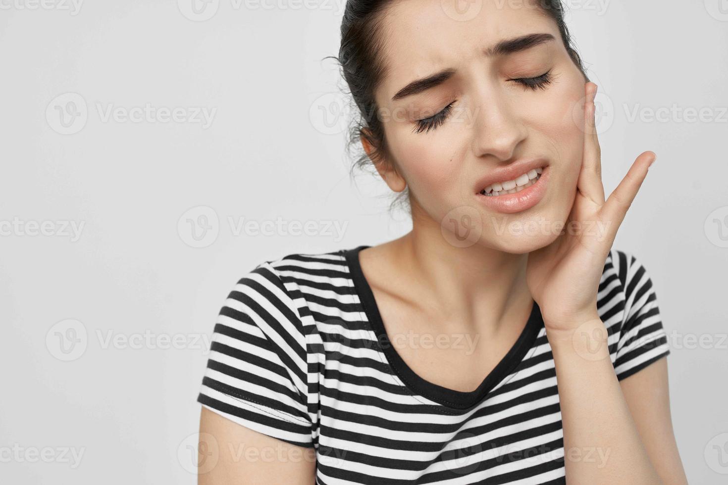 emotional woman discomfort toothache dental treatment light background photo