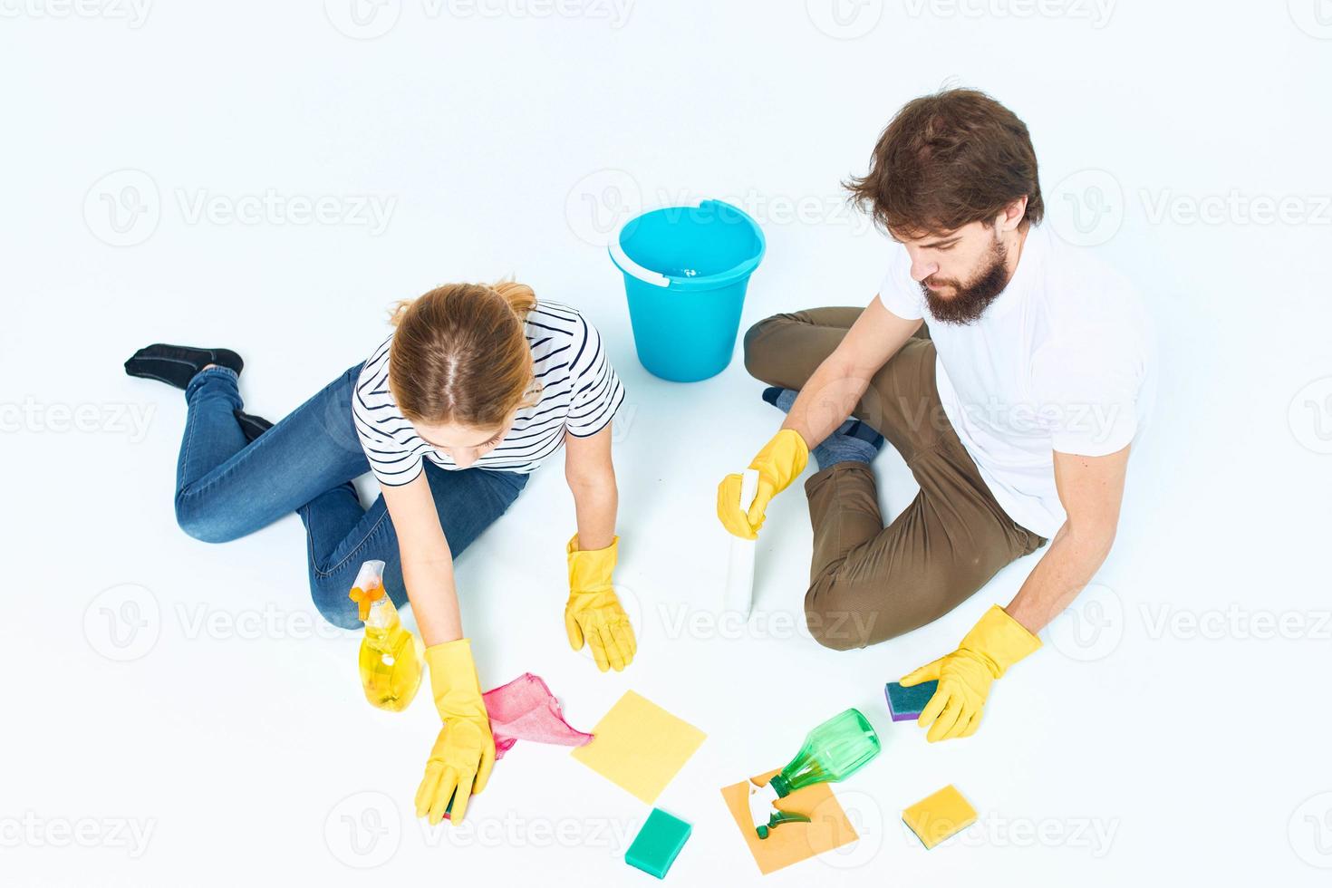 young couple washing floors cleaning supplies cleaning together homework photo