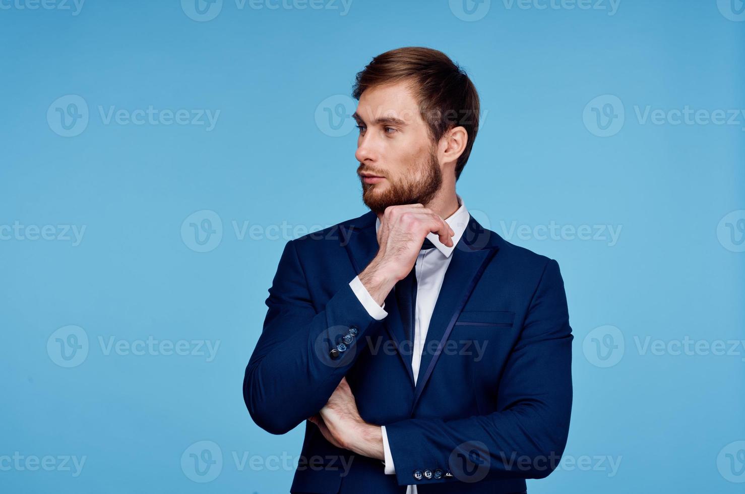 business man in suit blue background cropped view financial self-confidence photo