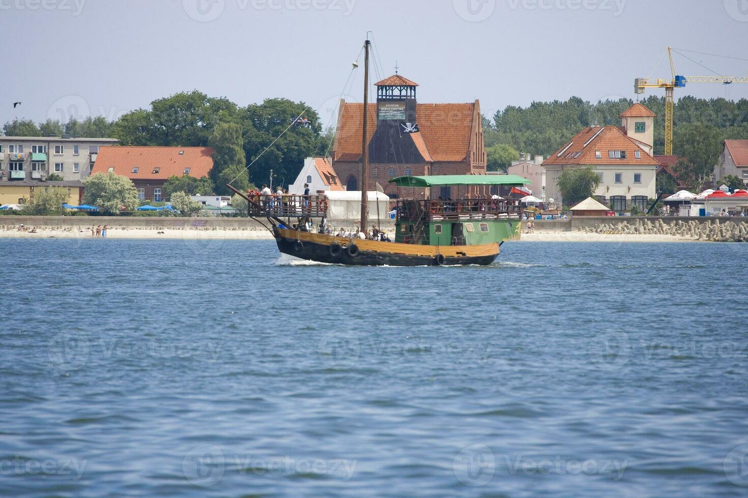 summer view from the sea of the city of Hel in Poland with a ship in the background photo