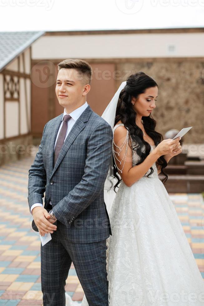 the first meeting of the bride and groom in the courtyard of the hotel photo