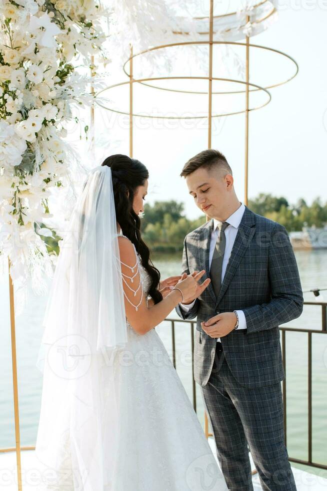 wedding ceremony of the newlyweds on the pier photo