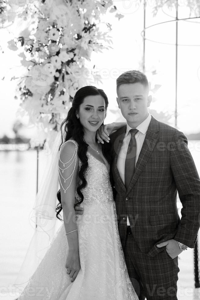 bride and groom against the backdrop of a yellow sunset photo