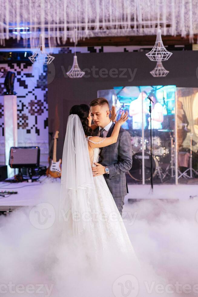 the first dance of the bride and groom inside a restaurant photo