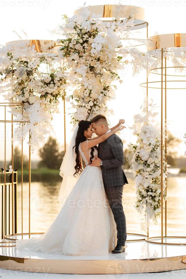 bride and groom against the backdrop of a yellow sunset photo