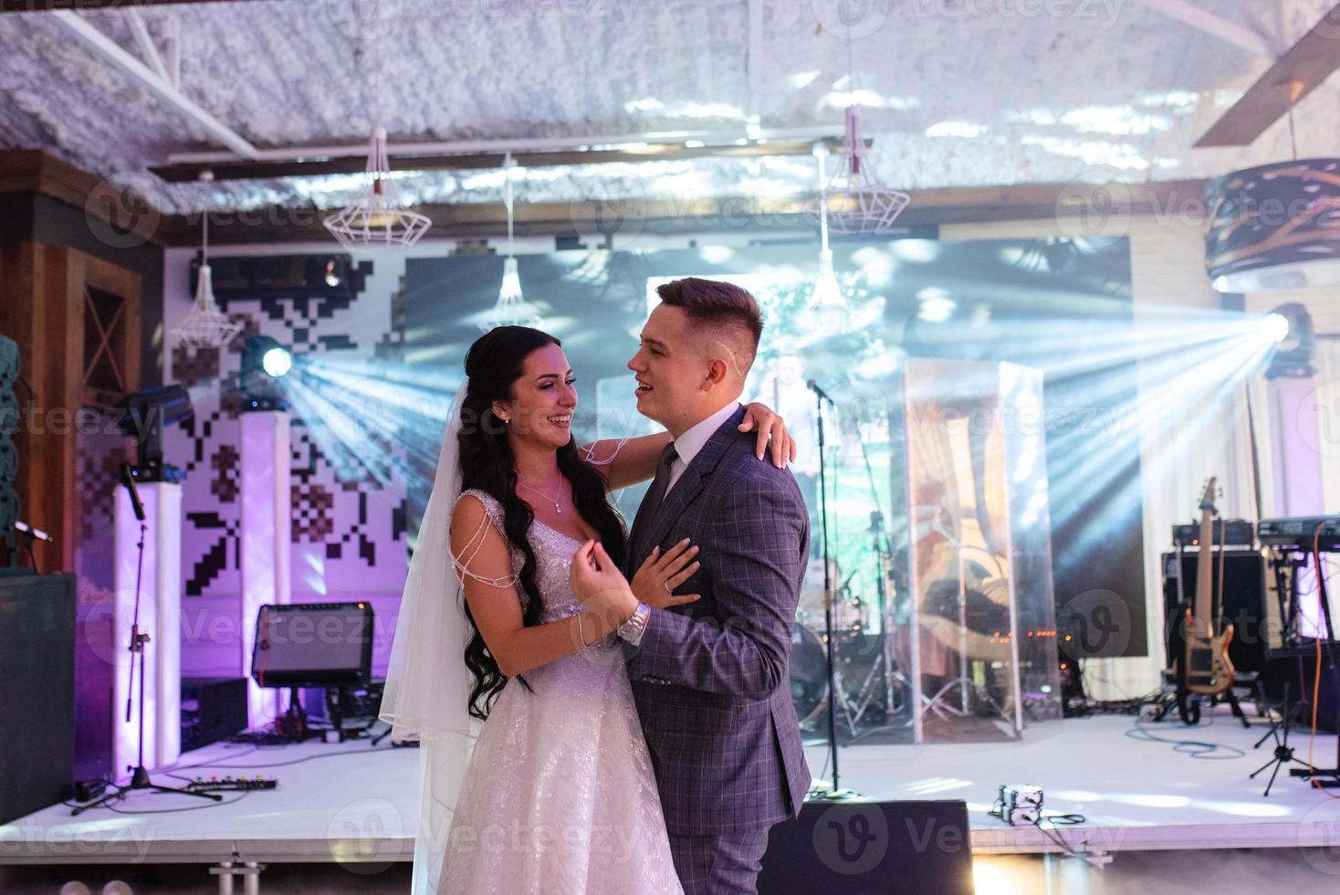 the first dance of the bride and groom inside a restaurant photo