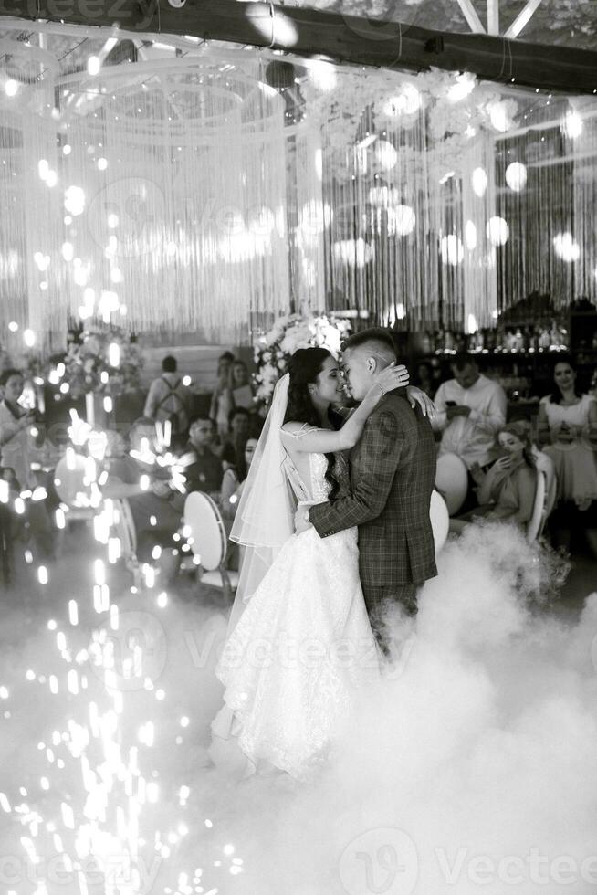 the first dance of the bride and groom inside a restaurant photo