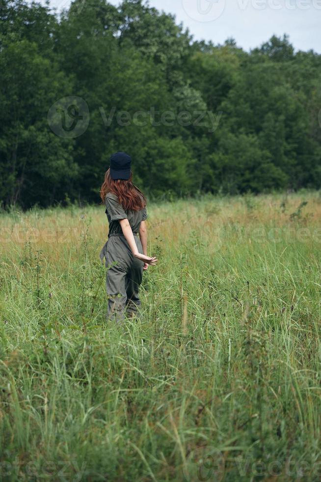 Woman on nature Walking through the field fresh air travel back view photo