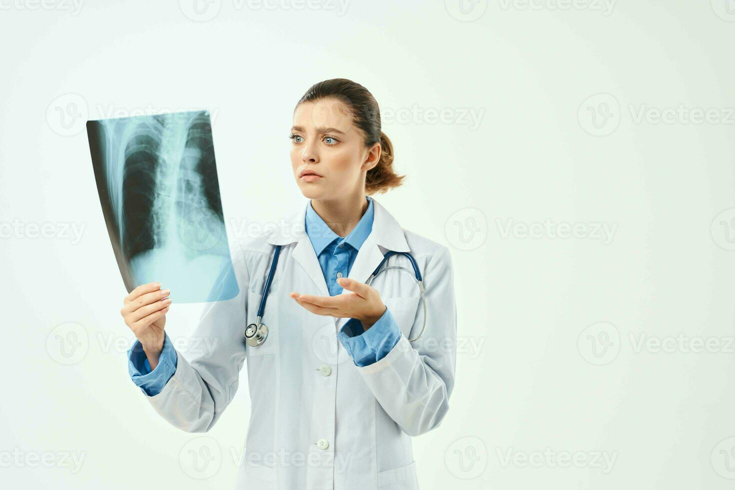 surprised radiologist showing x-ray emotion light background photo