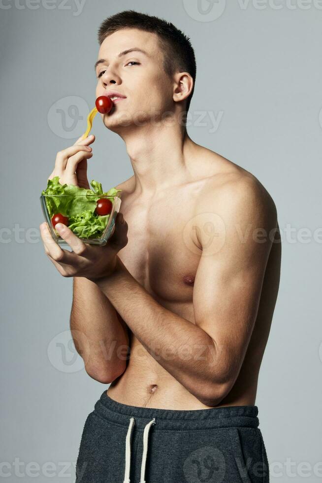 man with a plate of salad eating energy lifestyle isolated background workout photo