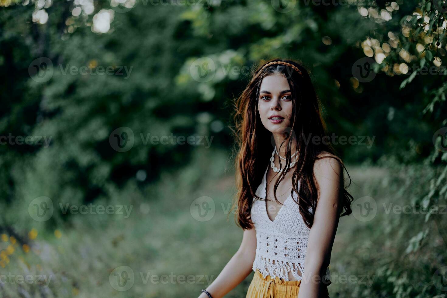 A woman dressed as a hippie with pigtails on her head travels outdoors at a campground in the fall and enjoys life photo