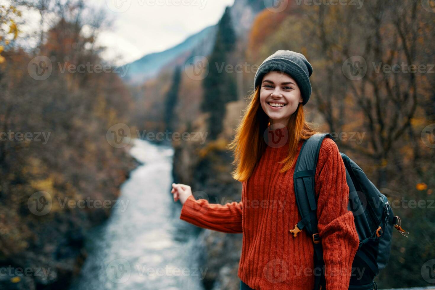 cheerful woman hiker on the bridge near the river mountains travel nature photo