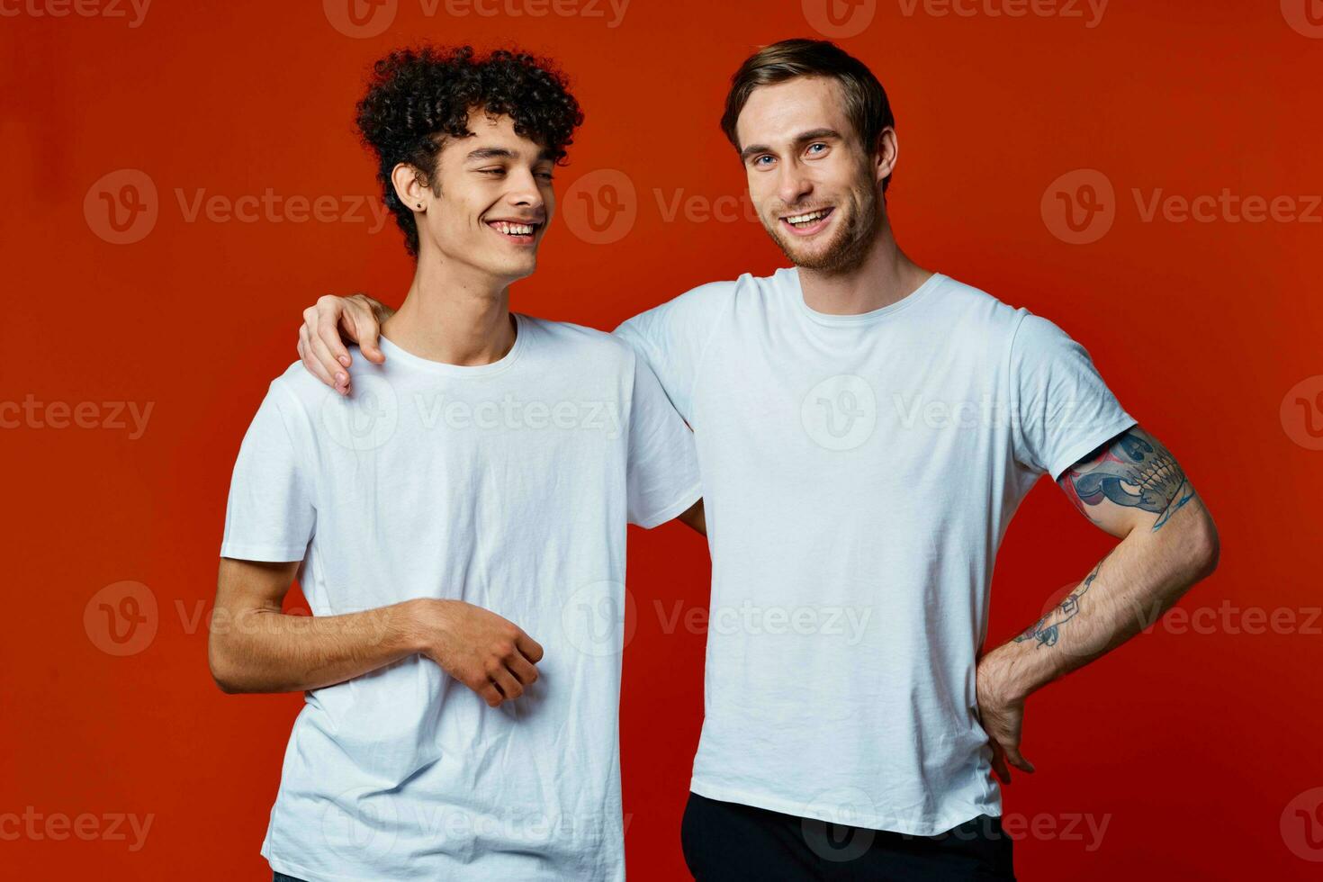 gracioso dos amigos en blanco camisetas posando estudio foto