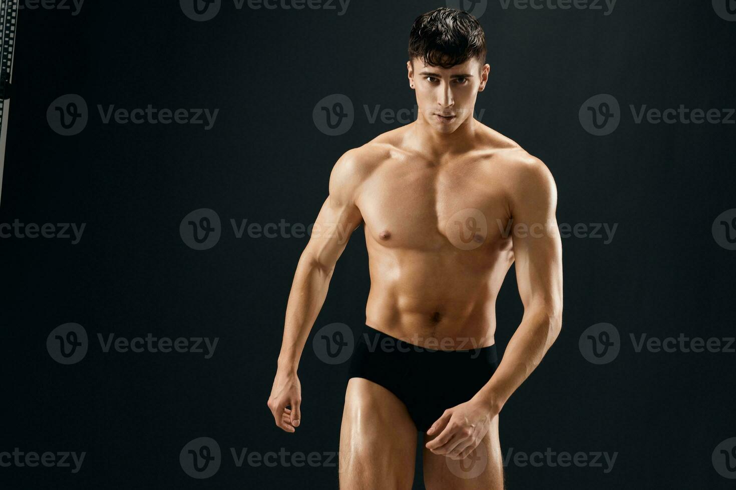 Attractive Athletic Man In Dark Briefs Studio Posing photo