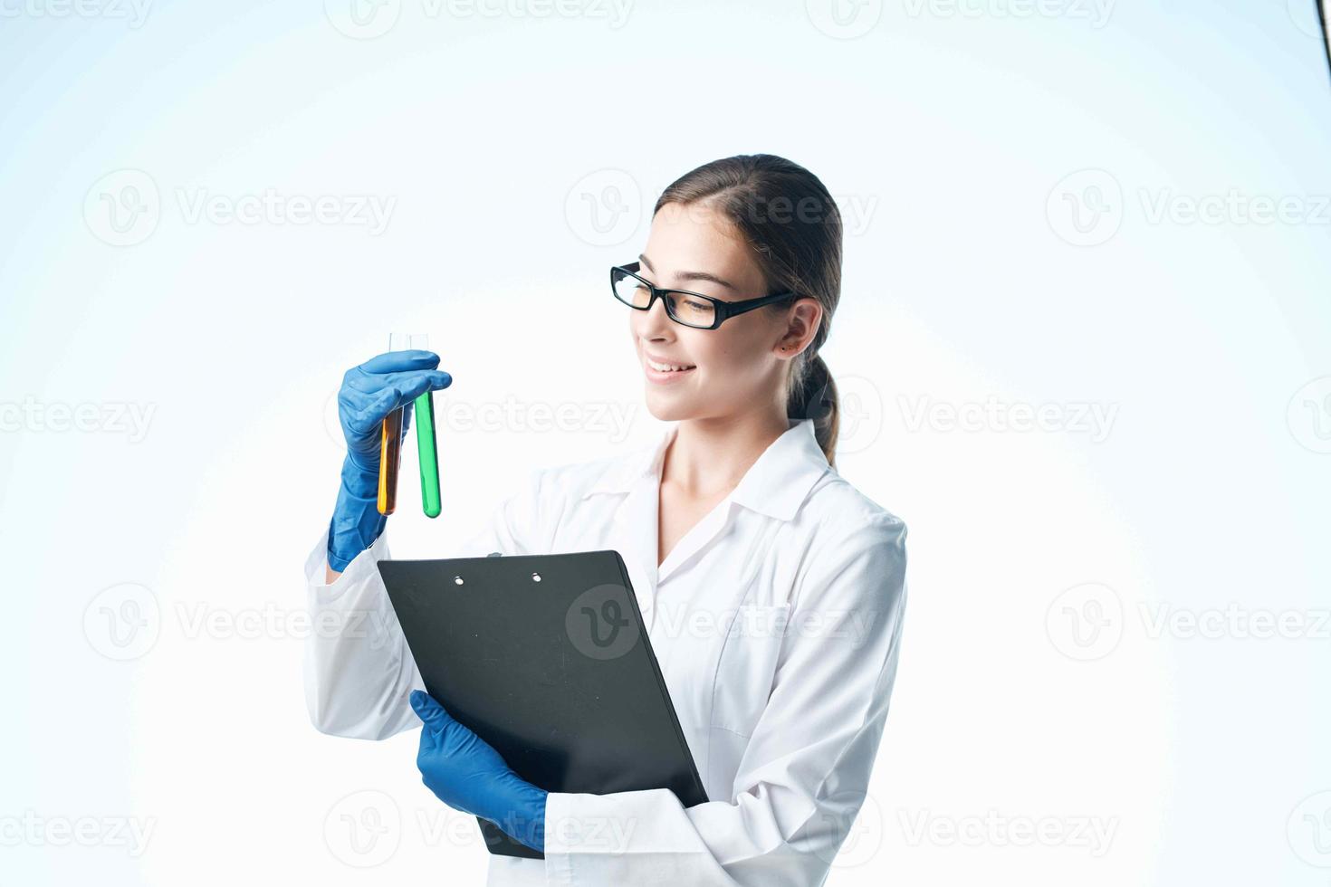 Woman in white coat laboratory research chemical solution analyzes photo