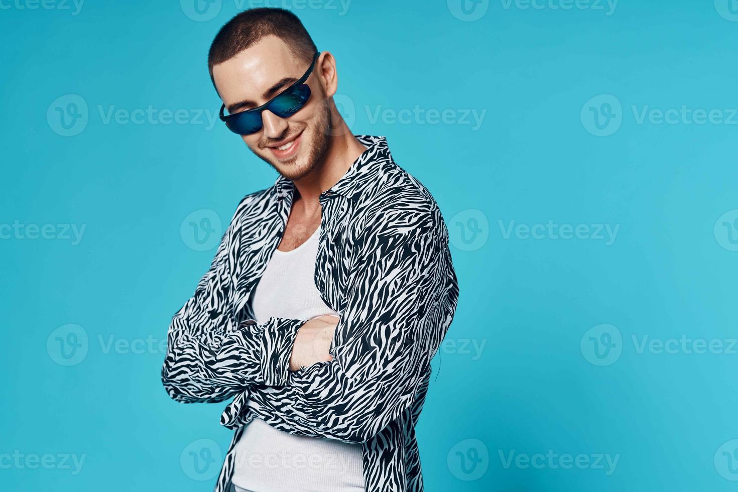 fashionable man with short hair in shirt studio blue background photo