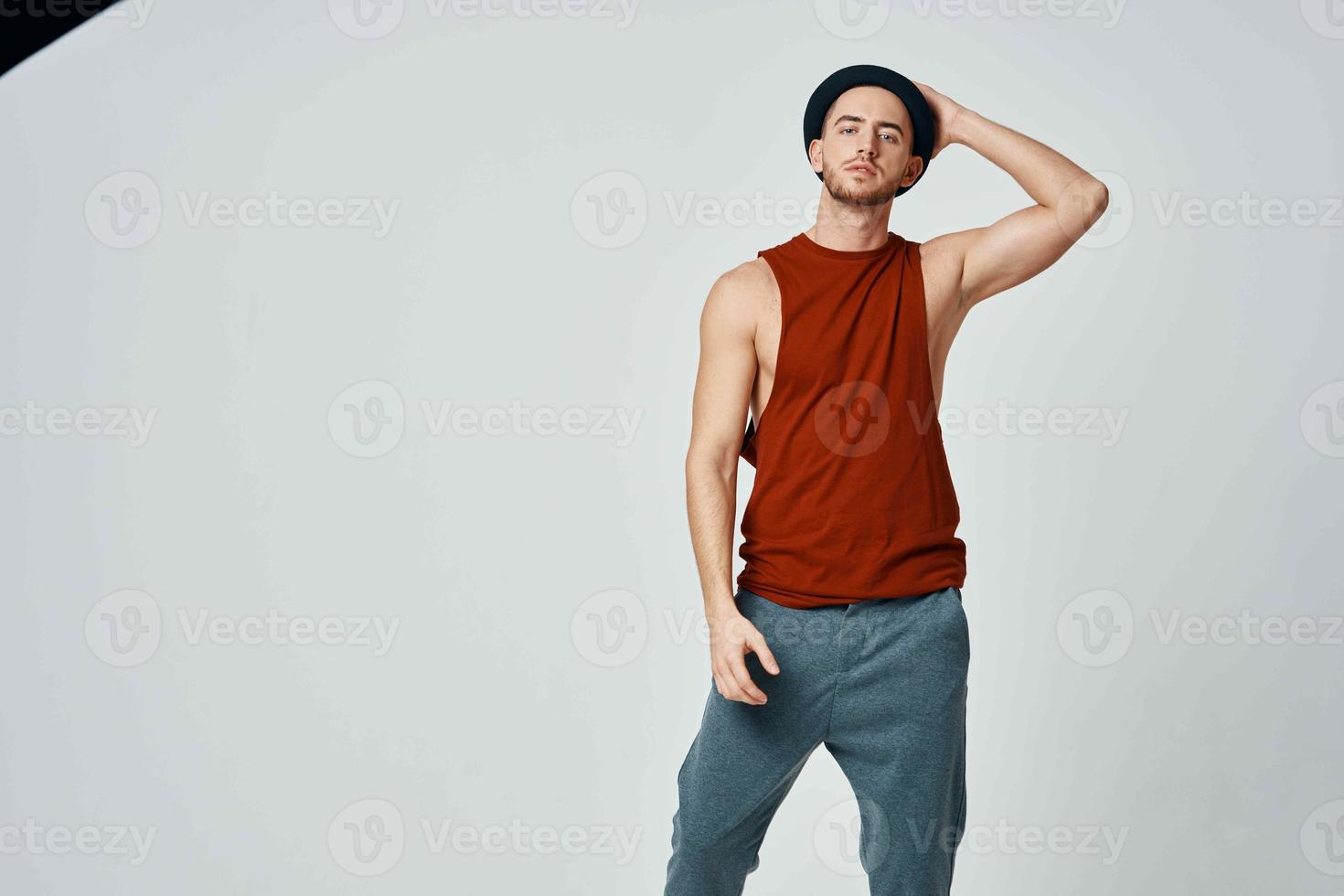 sexy man in red t shirt posing moda studio isolated background photo