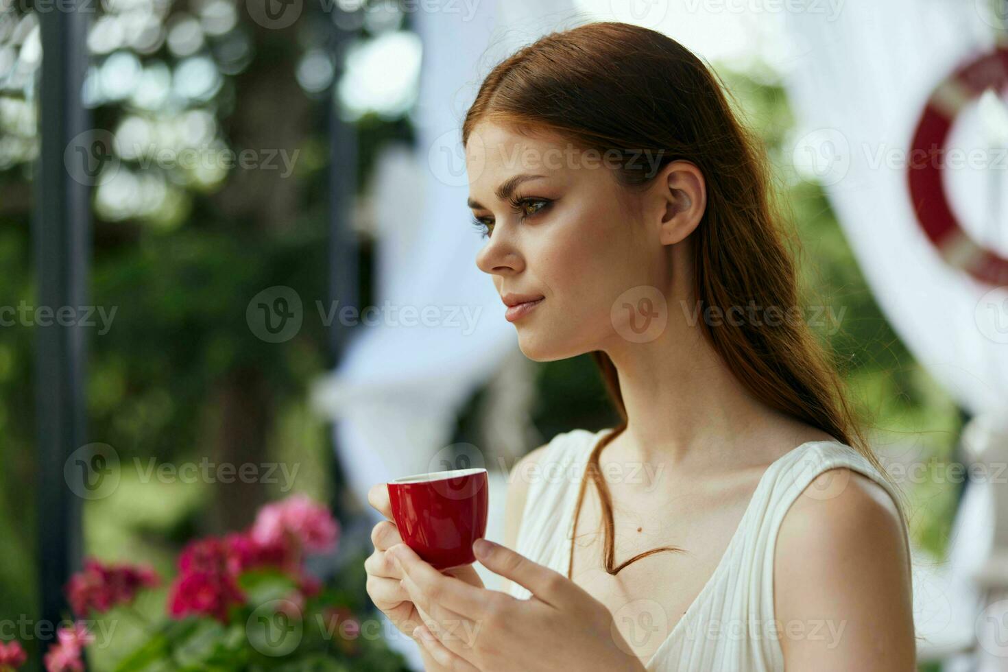 Portrait of young beautiful woman drinking coffee outdoors unaltered photo