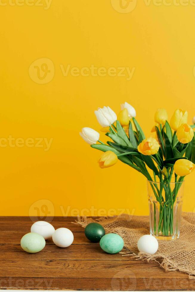 flowers easter eggs decoration holiday yellow background photo