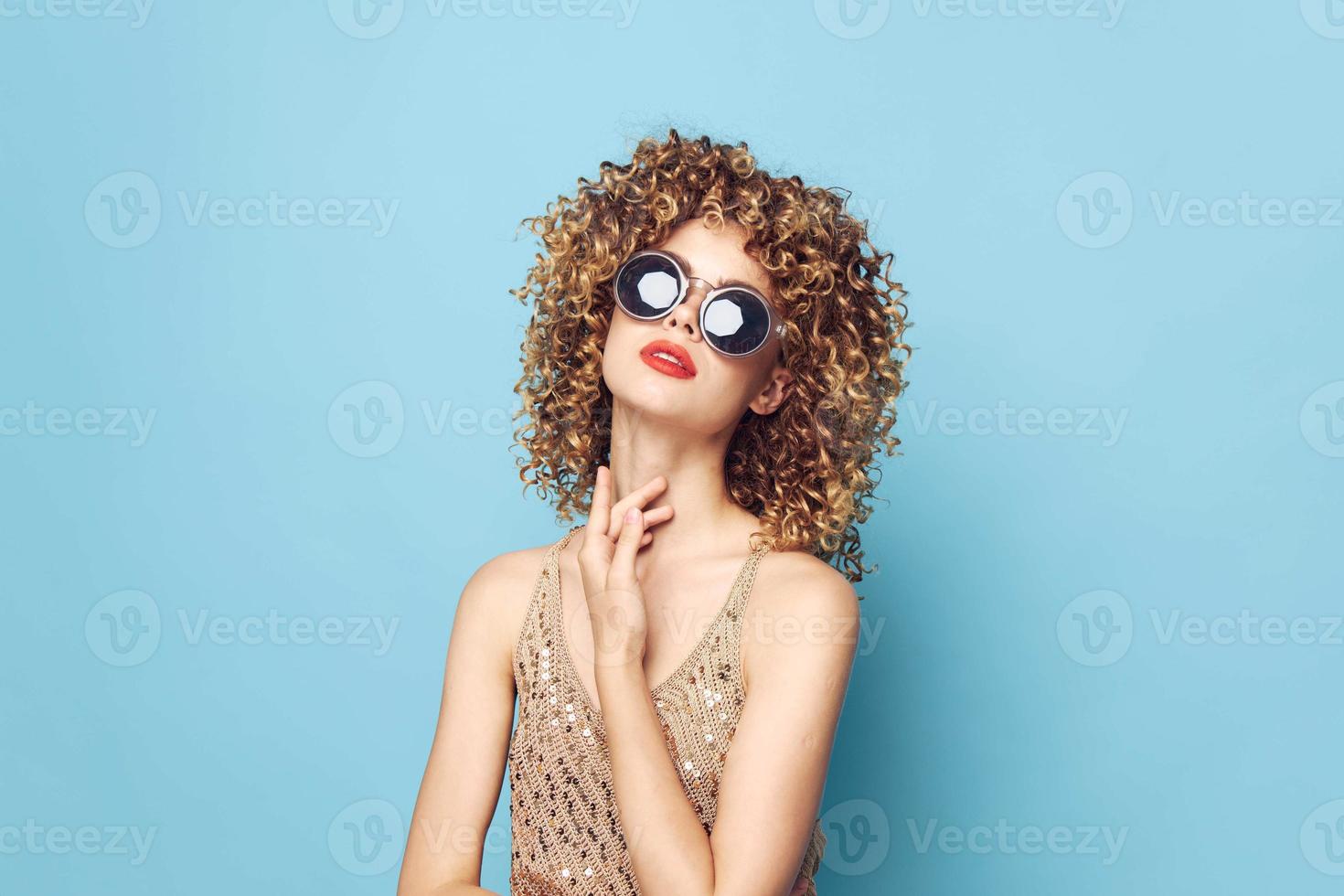 Pretty woman Elegant style curly hair red lips blue backgroundl bright makeup photo