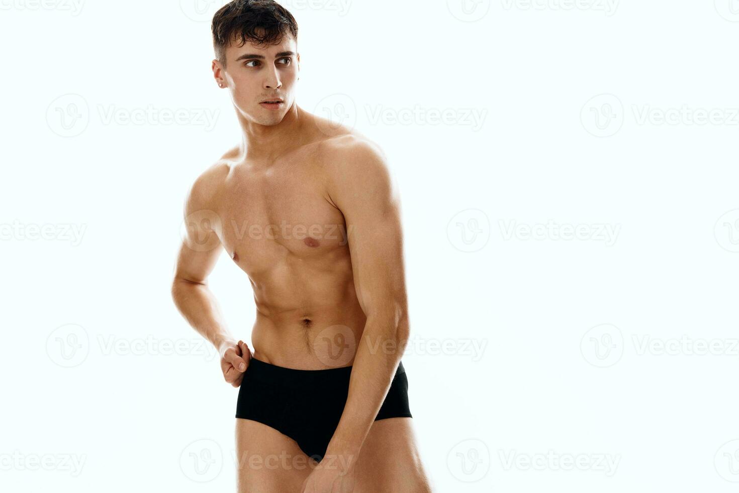 Athletic man with naked muscular body in dark workout panties photo