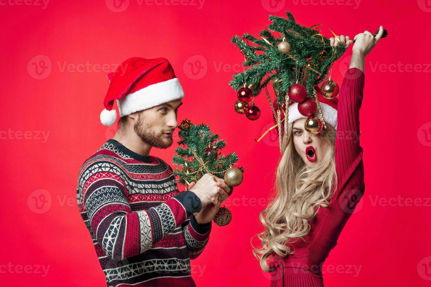 cheerful young couple christmas holiday red background decoration photo