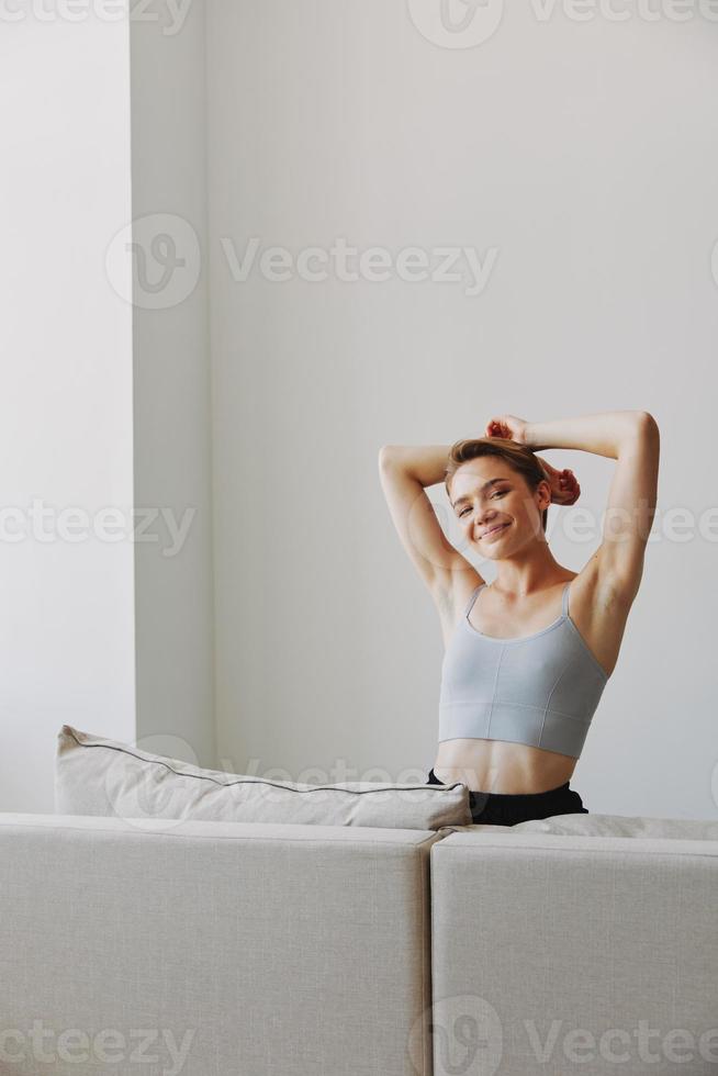 Happy woman smile lying at home on the couch relaxing on a weekend at home with a short haircut hair without filters on a white background, free copy space photo