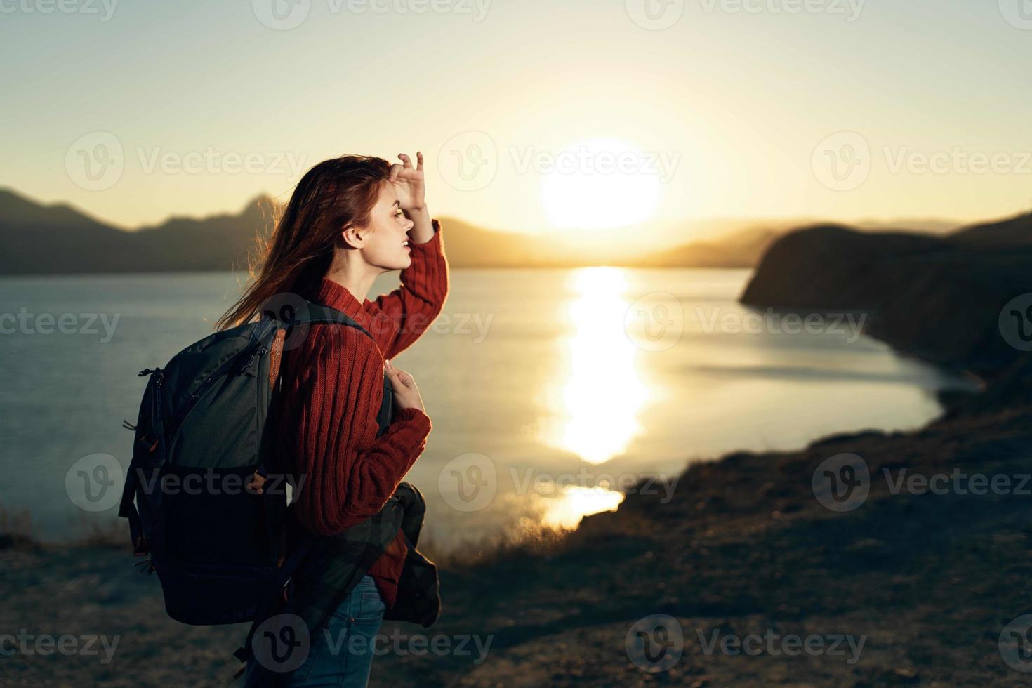woman with backpack sunset mountains travel freedom photo