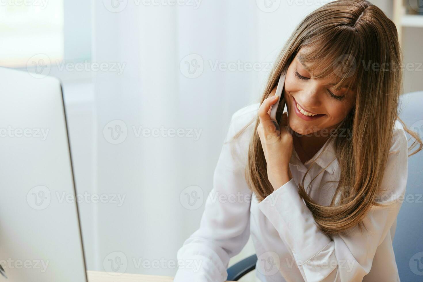 Smiling happy adorable blonde businesswoman worker freelancer talking with client in call in light modern office. Enjoyed employee work on computer online in support service. Copy space photo