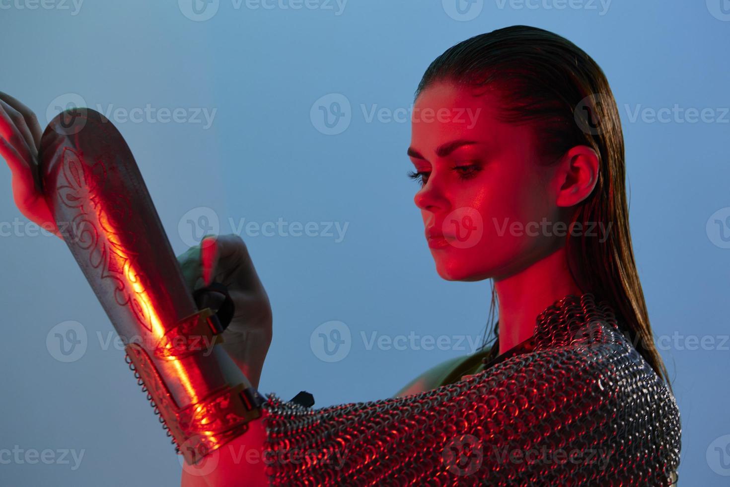 beautiful woman in dress arm in armor chain mail protection isolated background photo