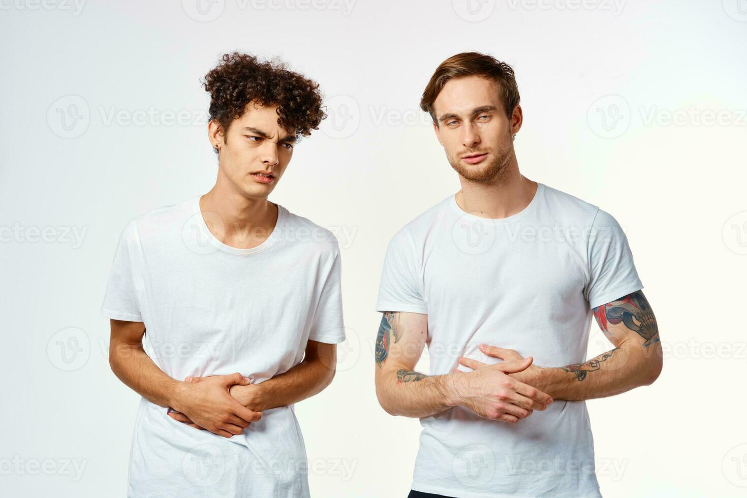 emotional two friends in white t-shirts yes fun studio photo