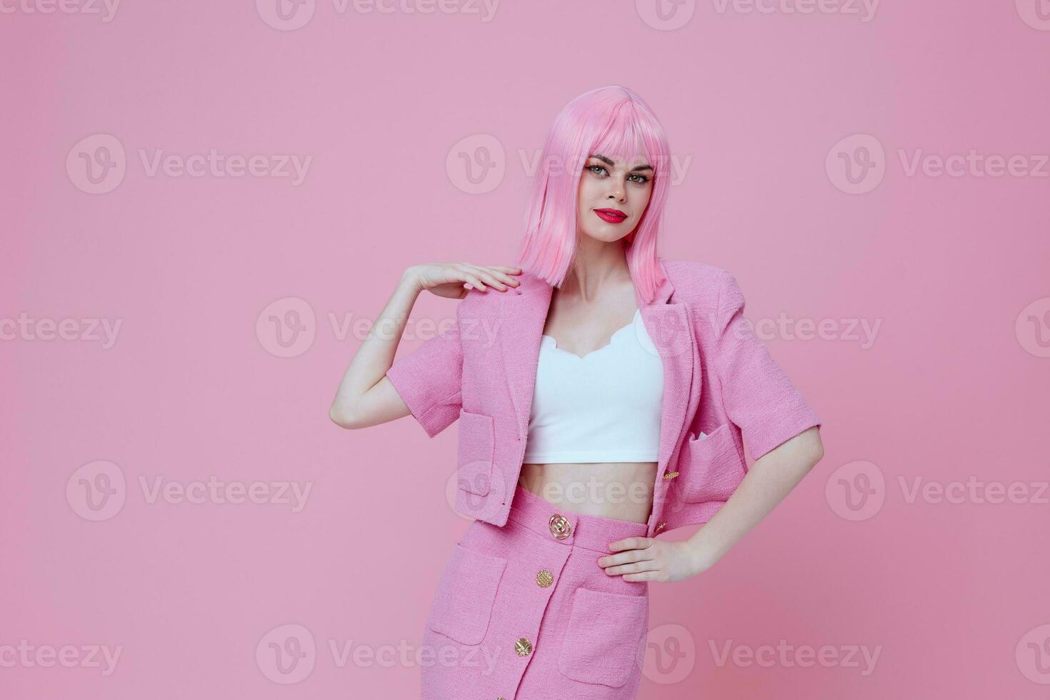 Young positive woman gestures with his hands with a pink jacket Studio Model unaltered photo