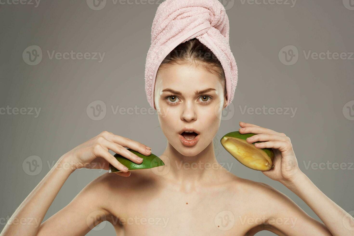 Beautiful woman with bare shoulders Exotic pure skin Mango in hand photo