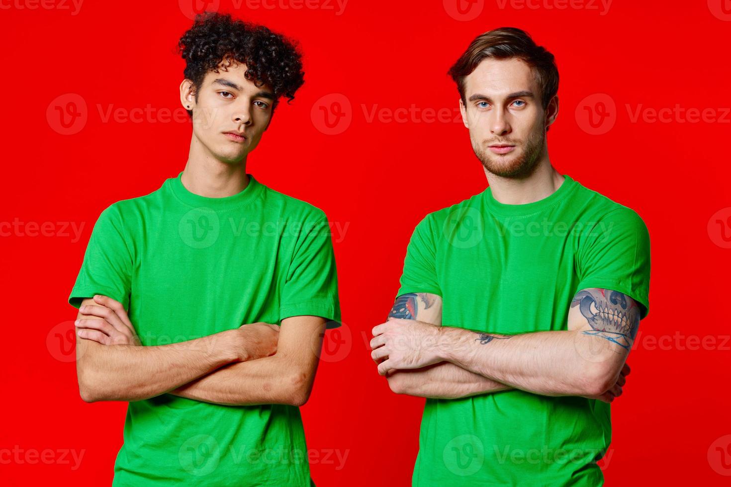 two friends green t-shirts fun red background communication photo