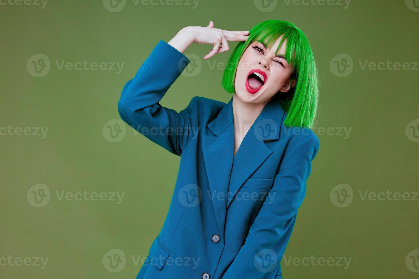 Pretty young female Glamor green wig red lips blue jacket color background unaltered photo