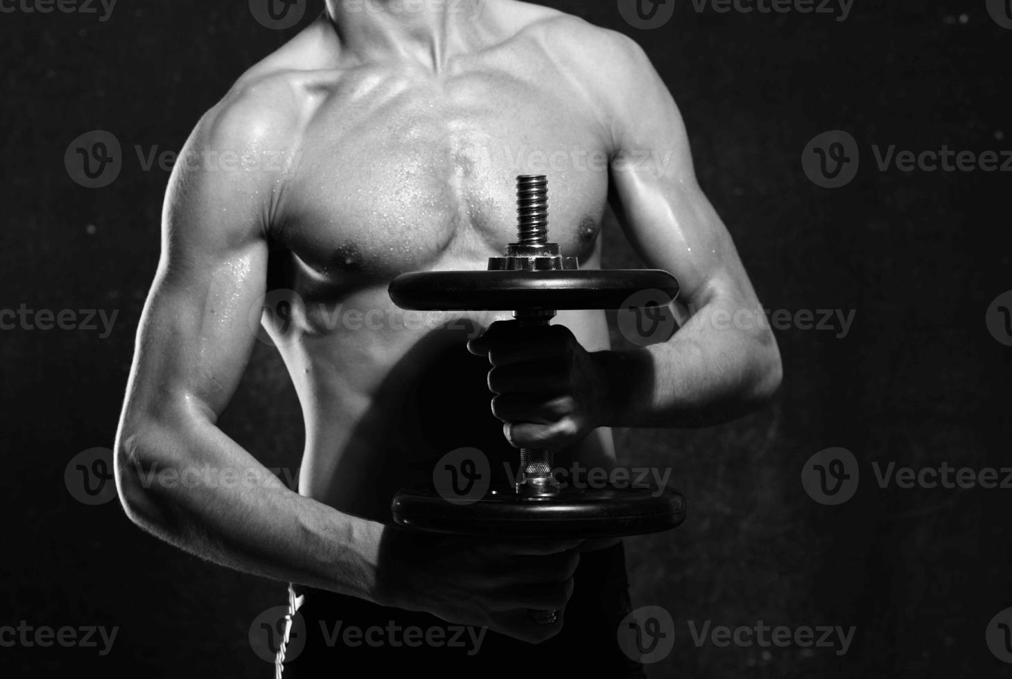 man in black shorts inflated torso black and white photo posing