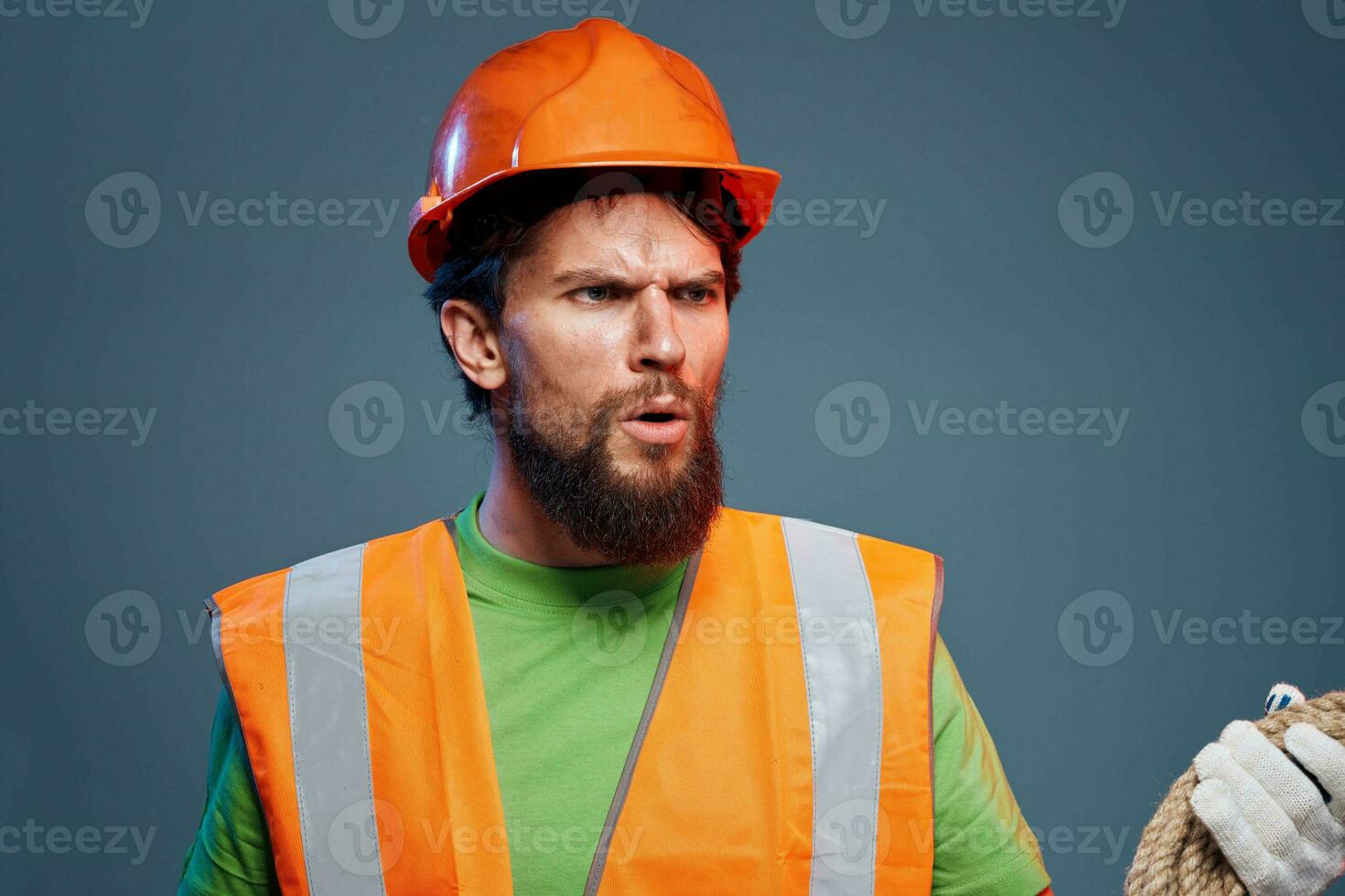 emotional worker construction uniform professional close-up blue background photo