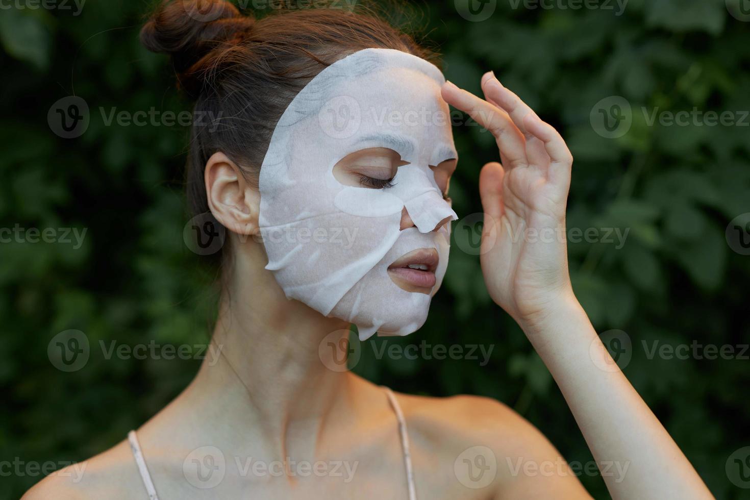 Beautiful woman Anti-wrinkle mask Closed eyes and transparent paper skin care leaves in the background photo