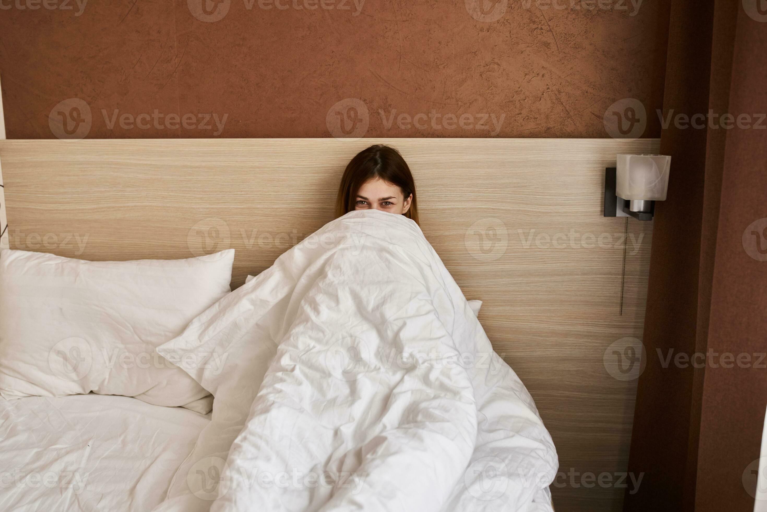 woman woke up early in the morning under the covers in bed 22522183