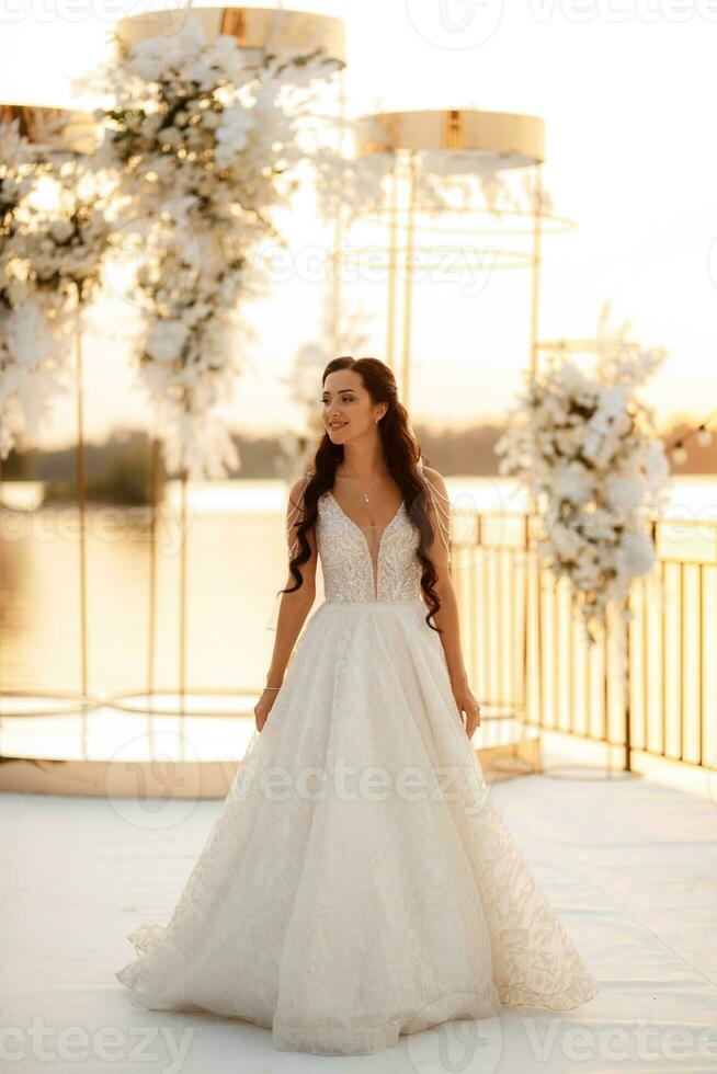 bride against the background of a yellow sunset photo