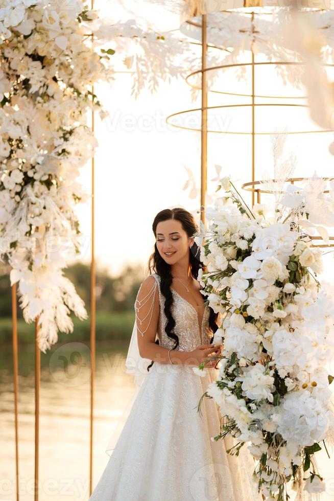 bride against the background of a yellow sunset photo