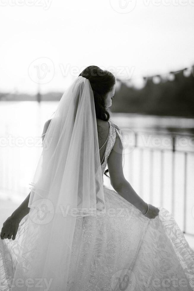 bride against the background of a yellow sunset photo